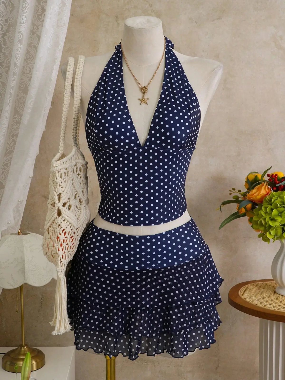 Beach Vacation Outfits: 9 Ideas for Easy Packing 6 Navy blue polka dot halter top and matching ruffled skirt on a white mannequin.
