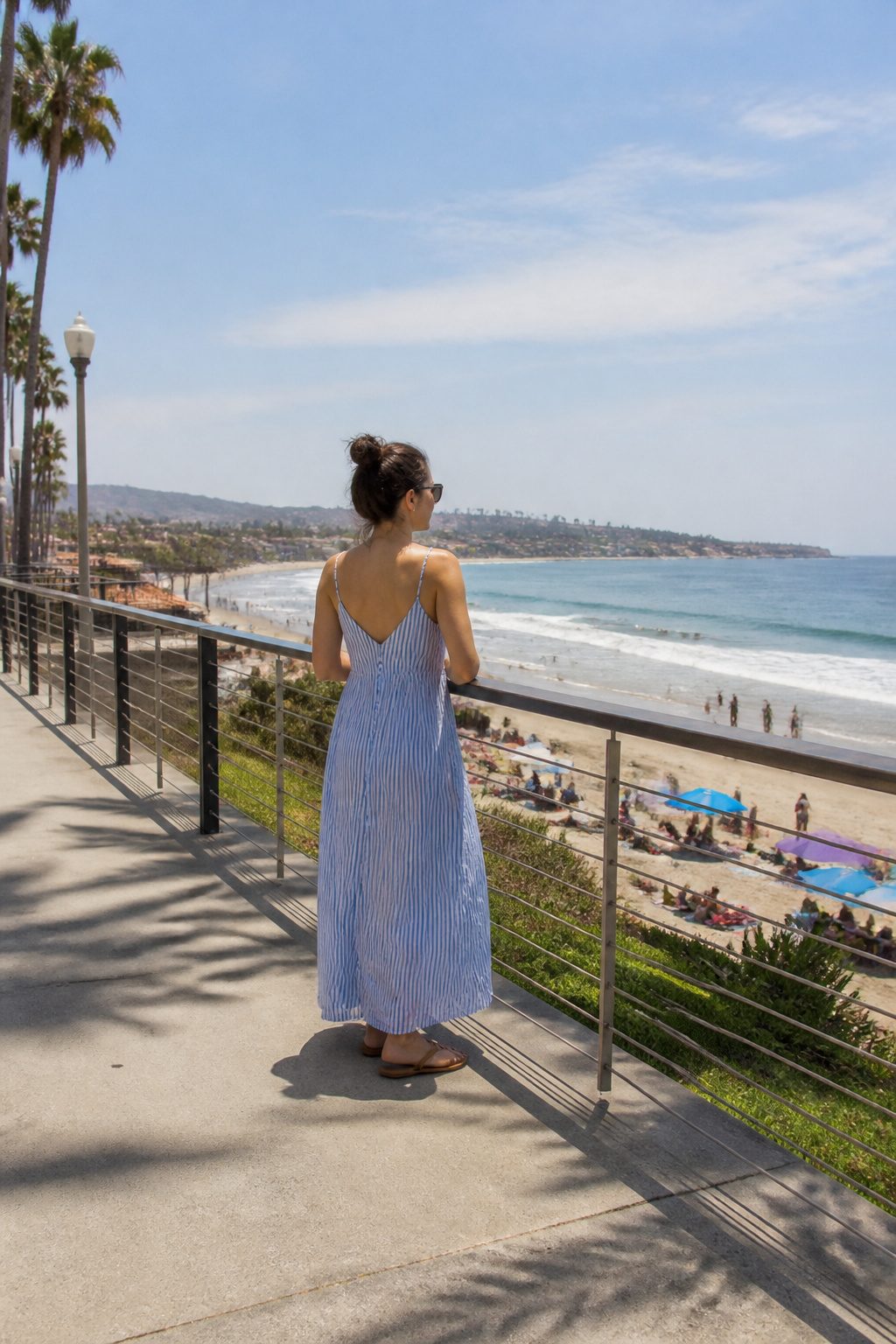 Model in the Molly Bracken Striped Maxi Dress with vertical stripes.