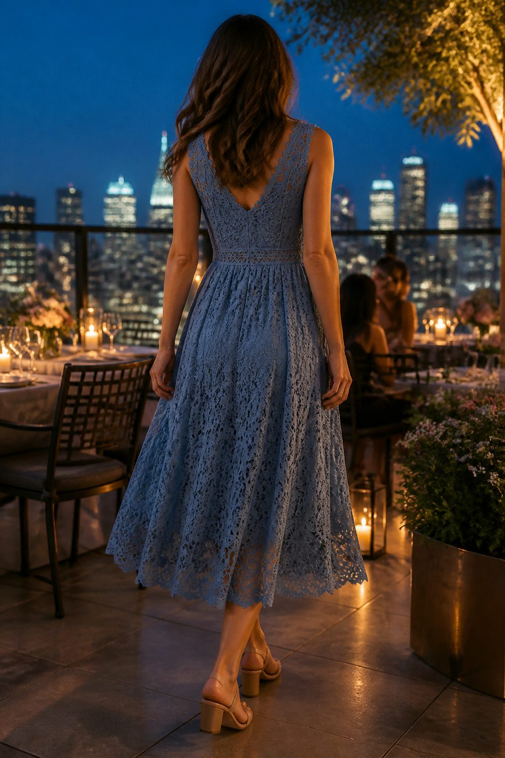 Model wearing the V-Neck Lace Dress at a candlelit rooftop event.