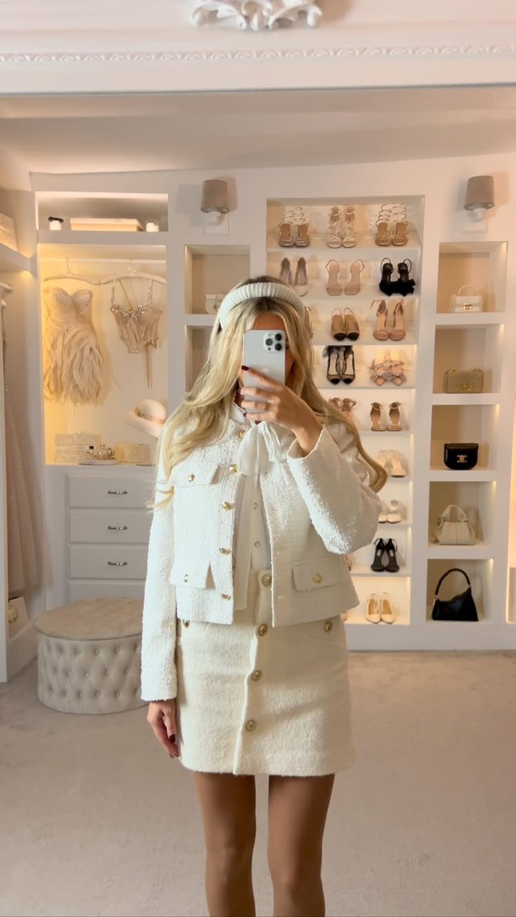 Business Casual Outfits for Work: 8 Polished Ideas 8 Woman in a white textured skirt suit posing for a mirror selfie in a walk-in closet.