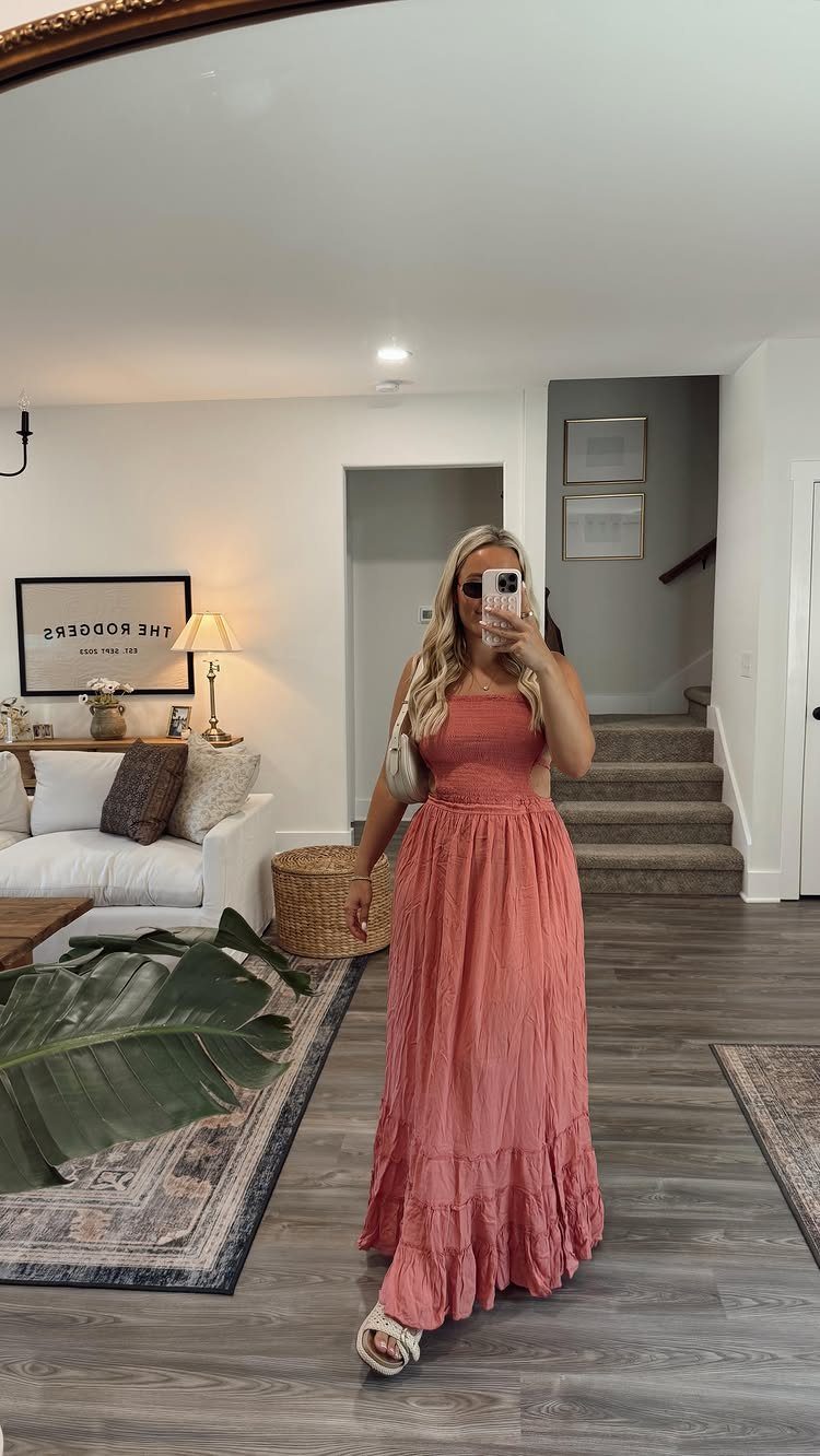 Casual Summer Outfits: 10 Easy Ideas for Daily Wear 3 A woman posing in a long, coral-colored strapless maxi dress and white sandals.
