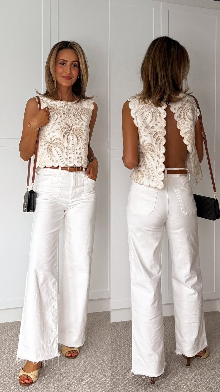 10 Chic Summer Outfits: Sandals, Linen, Dresses and More 8 Woman wearing a white lace sleeveless top and white wide-leg denim trousers standing against a white wall.