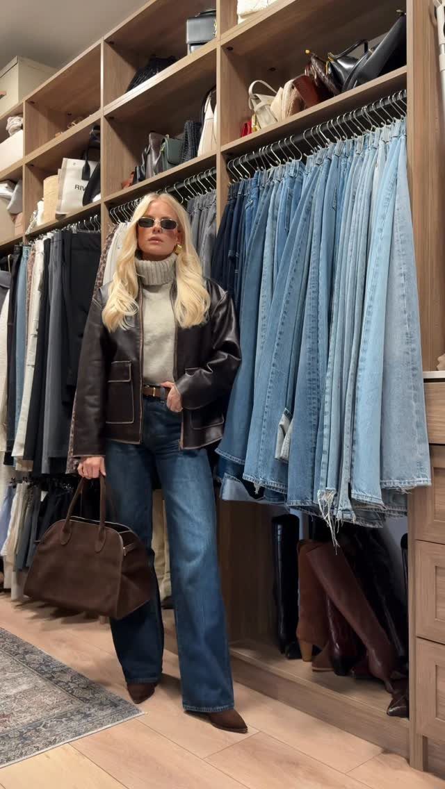 26 Classy Date Outfits From Casual to Elegant 10 Woman in brown leather jacket and wide-leg blue jeans posing in a clothing store.