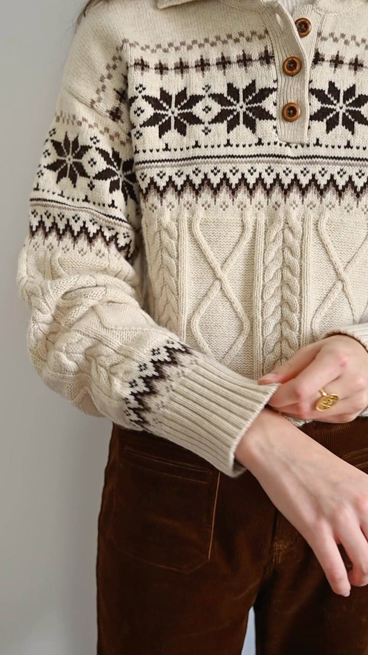 Cream cable-knit sweater with brown Fair Isle pattern and brown corduroy trousers.