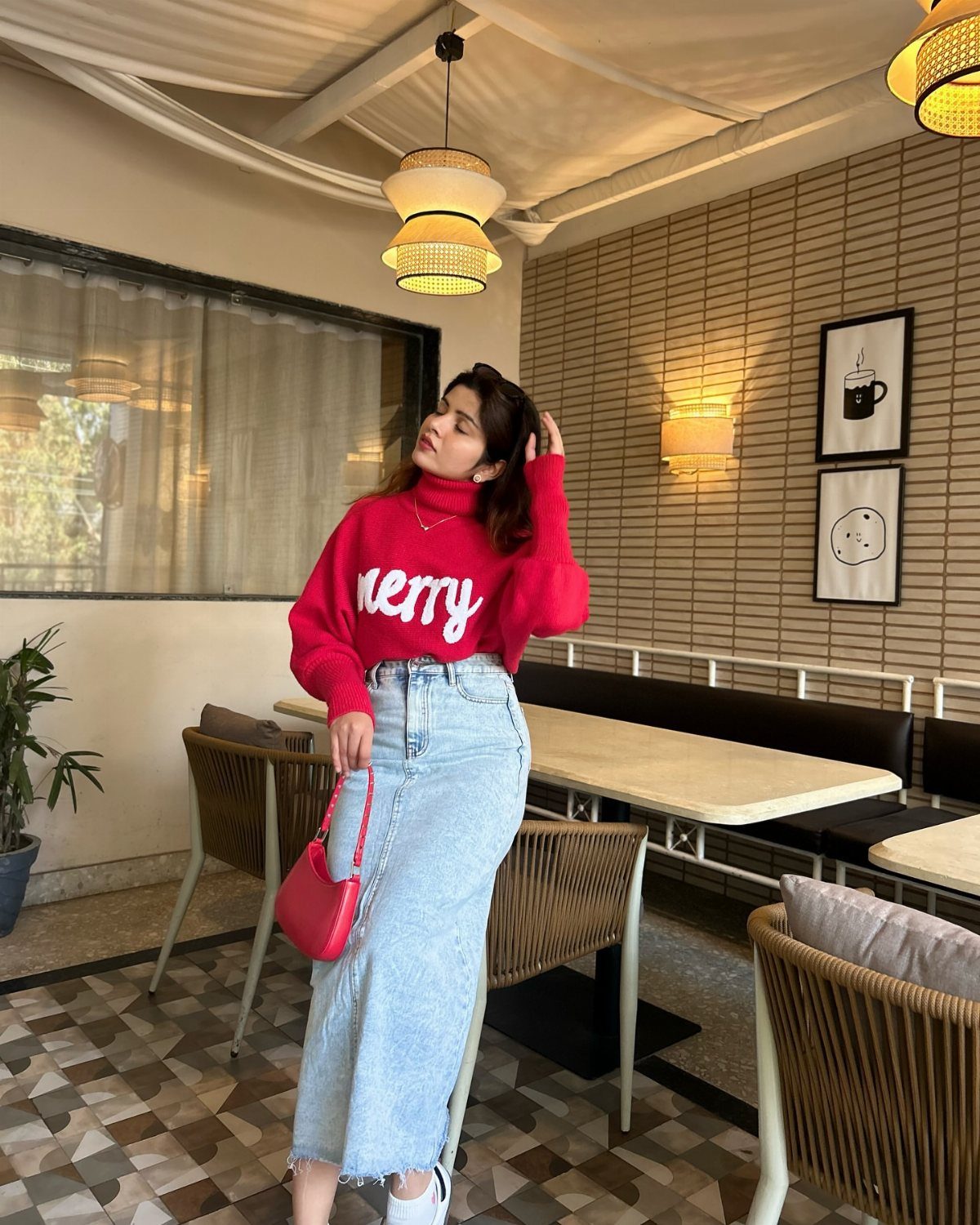 Denim Skirt Outfits: 19 Ways to Style Them This Season 7 Woman in red chunky knit sweater and light blue denim midi skirt in cafe.
