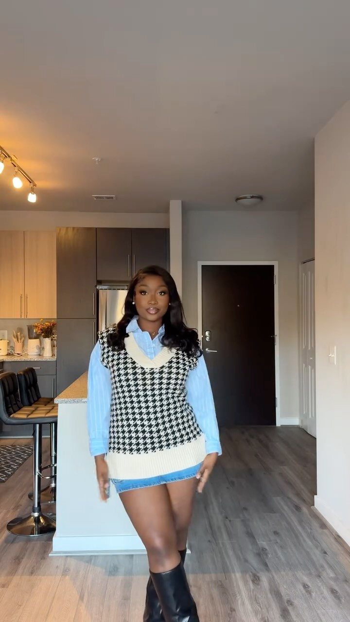 Denim Skirt Outfits: 19 Ways to Style Them This Season 15 Woman wearing a denim mini skirt, houndstooth sweater vest, and black knee-high boots.