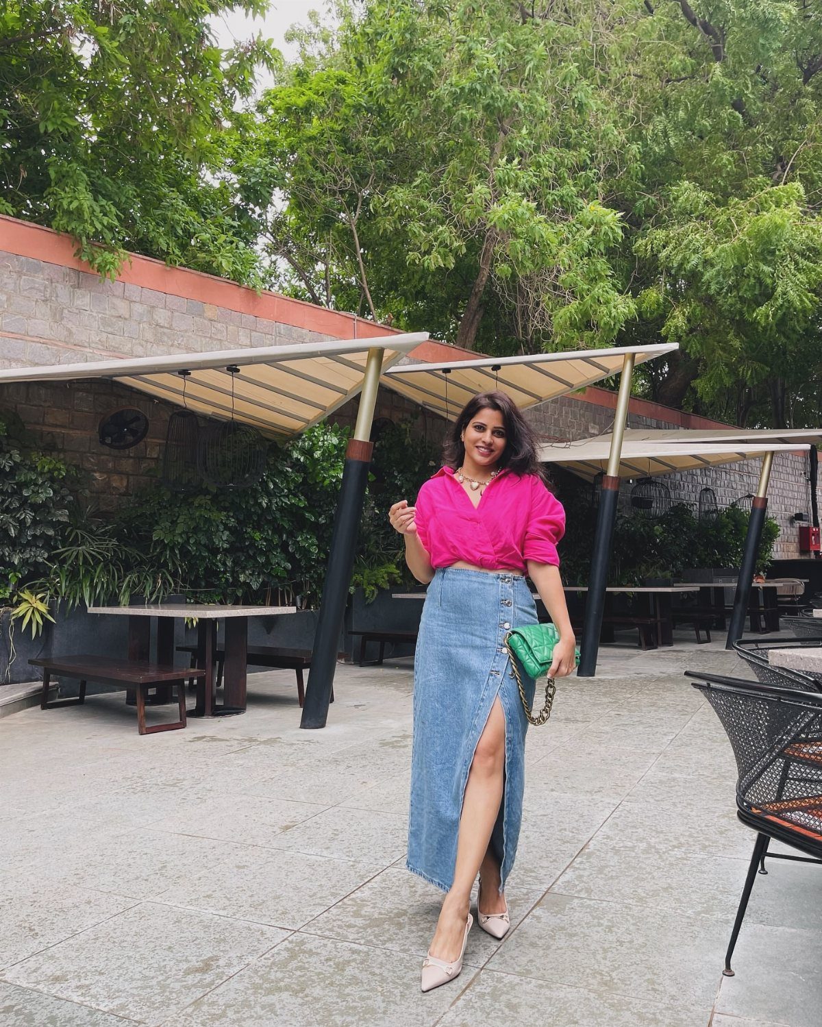 Denim Skirt Outfits: 19 Ways to Style Them This Season 17 Woman wearing a pink puff-sleeve top and long blue denim skirt with beige heels.