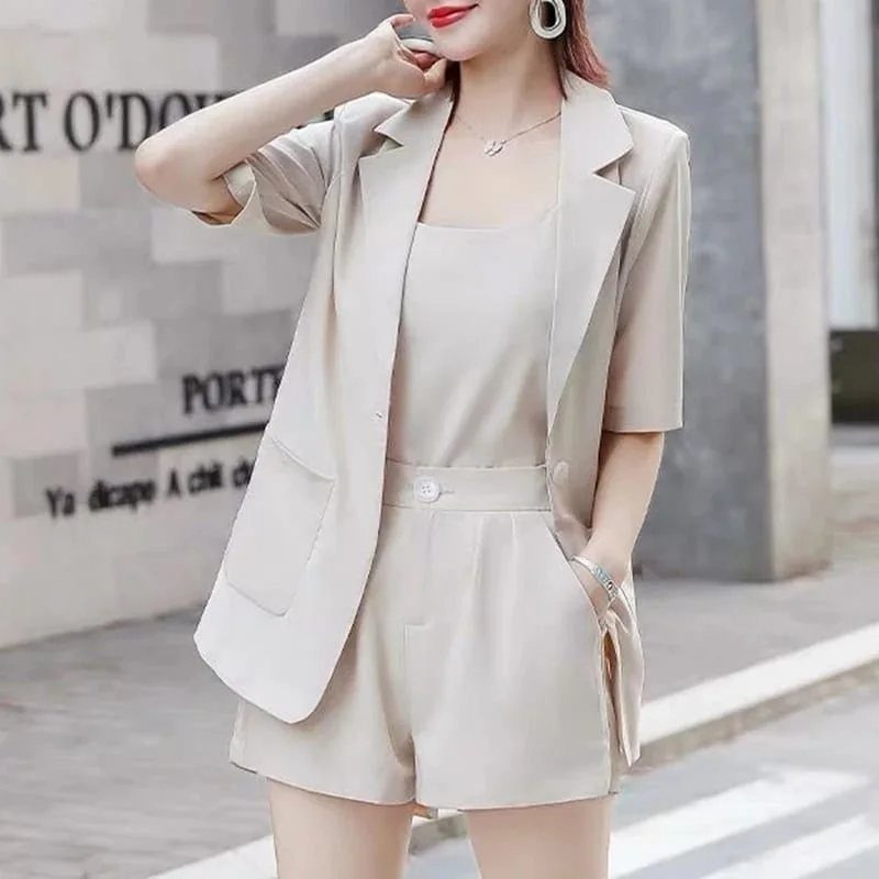 Woman wearing a light beige short-sleeved blazer set with matching shorts and top.