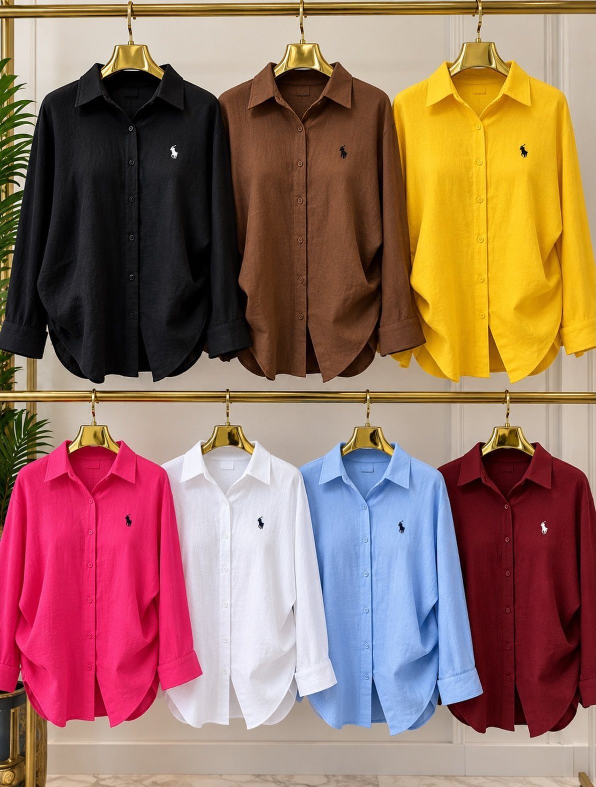 Linen Fashion Women: 6 Outfit Upgrades for 2026 6 Seven colorful linen button-down shirts hanging on gold hangers on a clothing rack.