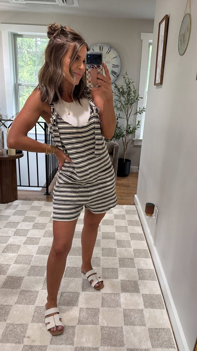 Outfit for Vacation: 13 Ideas for Every Island Moment 8 Woman posing in a striped romper and white sandals for a casual outfit look.