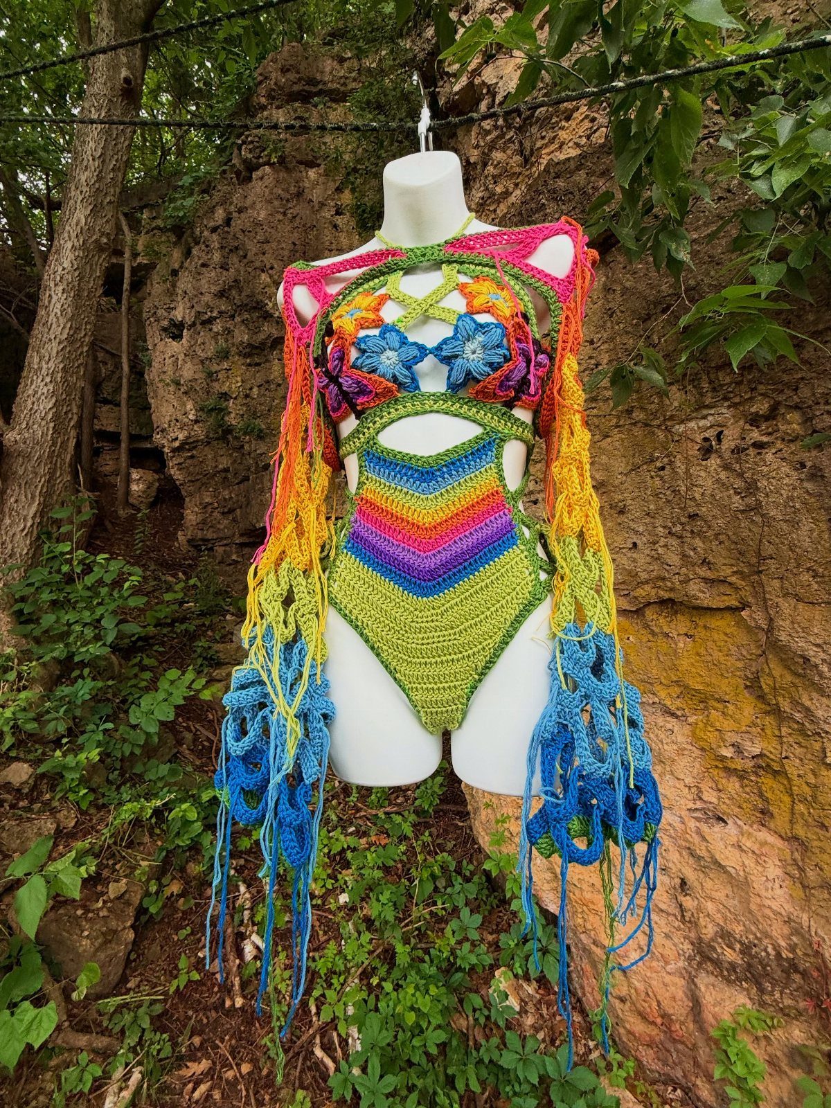 Outfit Ideas for Cancun: 13 Looks for Every Occasion 13 Colorful crochet bodysuit with rainbow stripes and floral details on a white mannequin.