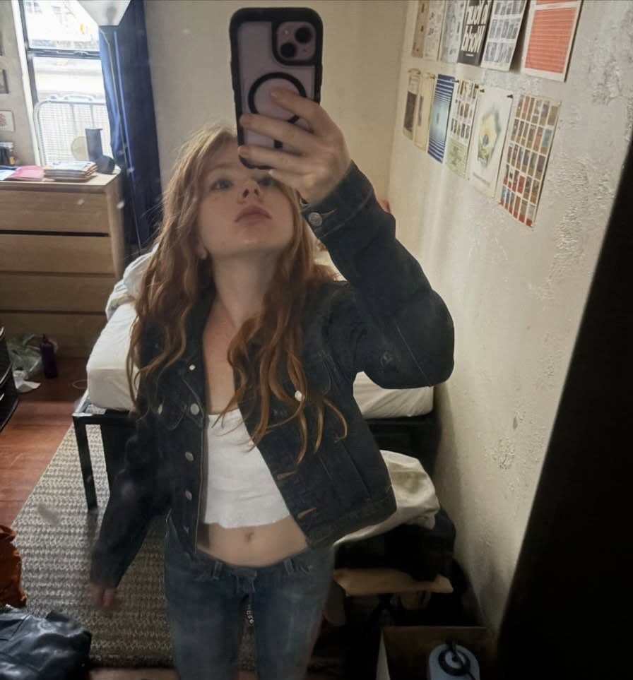 11 Outfits for Teens: Street to Semiformal Style Ideas 6 A young woman posing in a denim jacket, white camisole, and blue jeans.