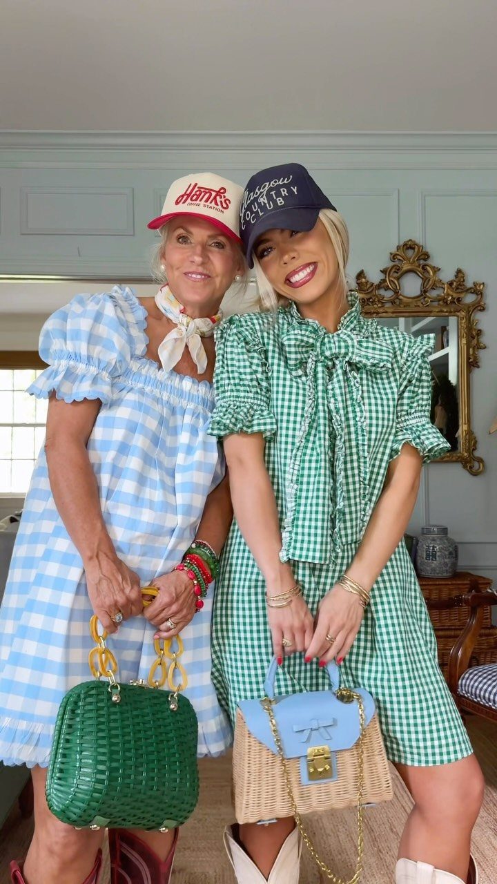 15 Preppy Summer Outfits to Wear All Season Long 6 Two women wearing blue and green gingham dresses and baseball caps posing indoors.