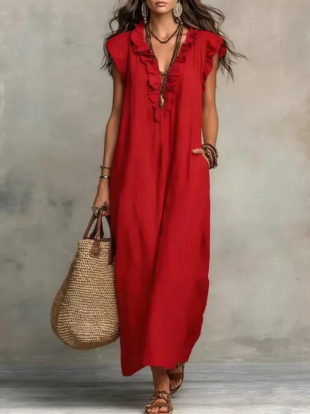 Red Summer Dress: 6 Looks for Warm Days and Nights 1 Woman in a sleeveless red linen maxi dress holding a large woven straw tote bag.