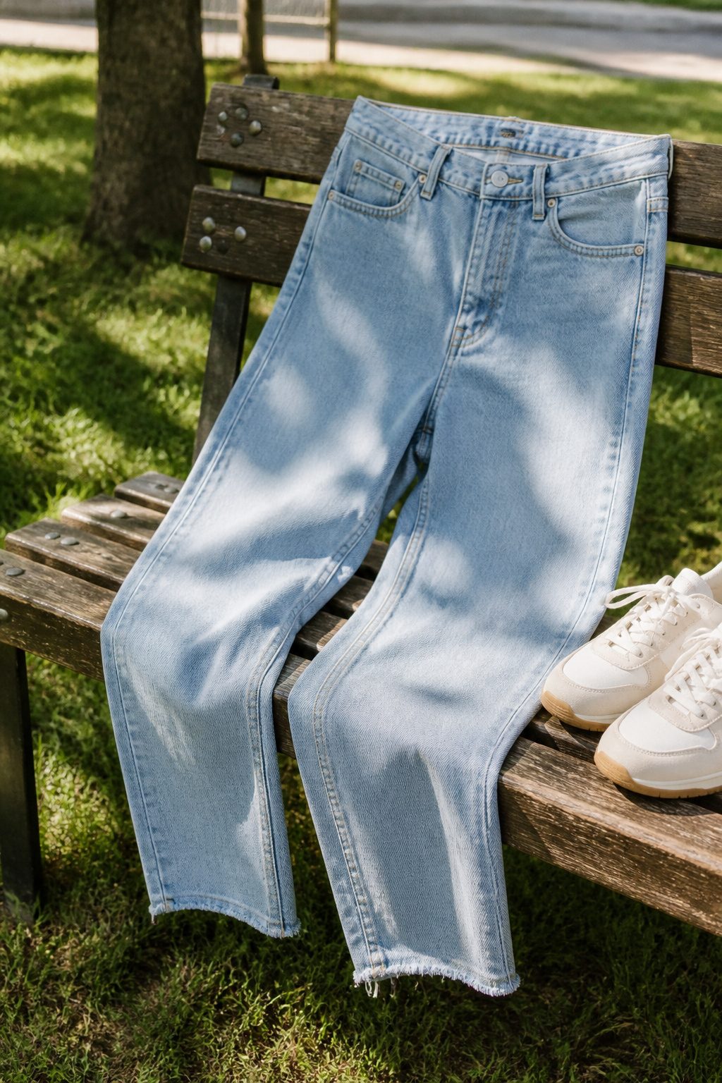 A pair of mid-rise straight-leg denim jeans displayed.