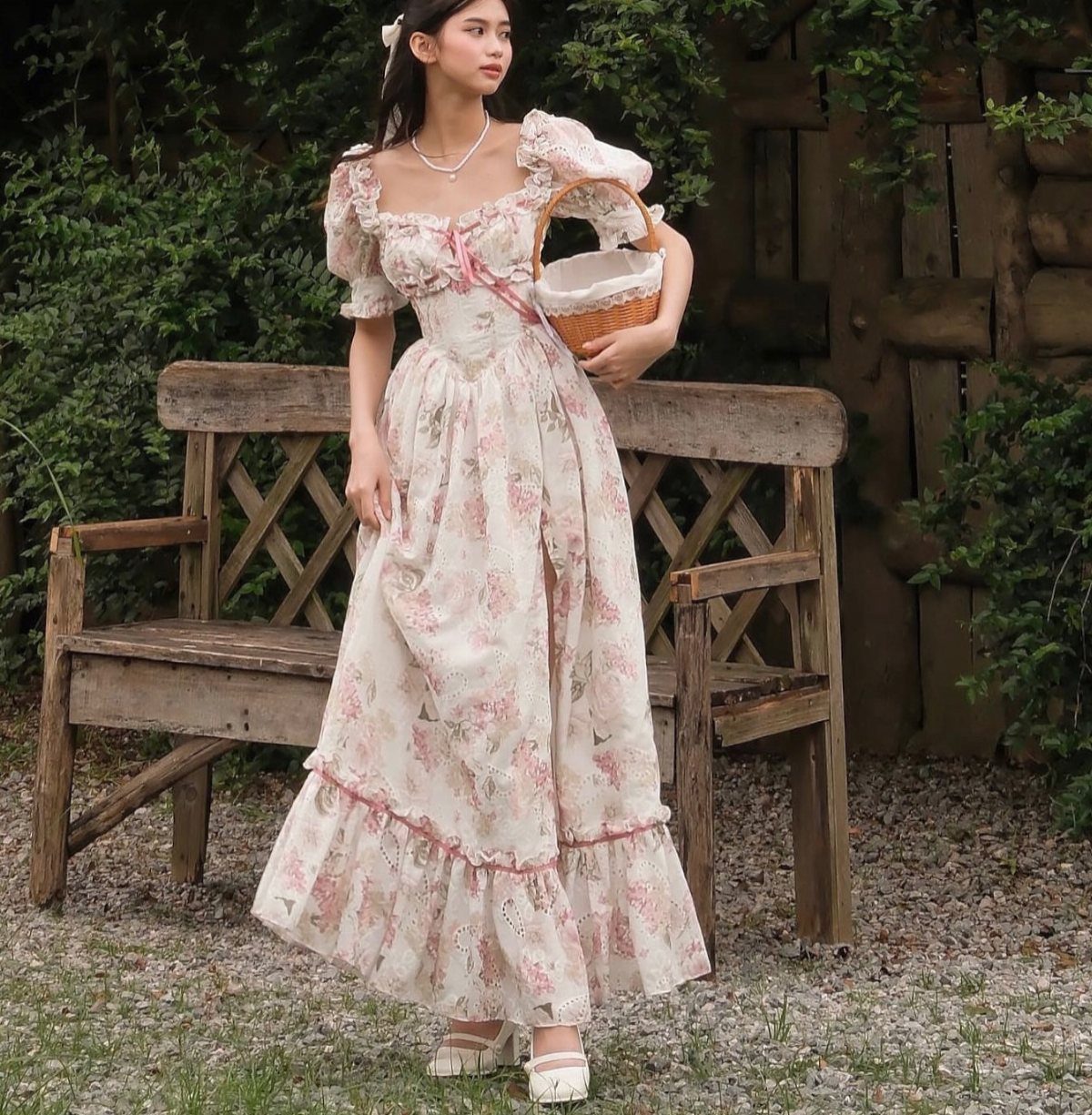 Tea Party Dresses: 6 Outfit Ideas for Brunches and Garden Events 6 A woman in a floral cottagecore dress holding a wicker basket in a garden.