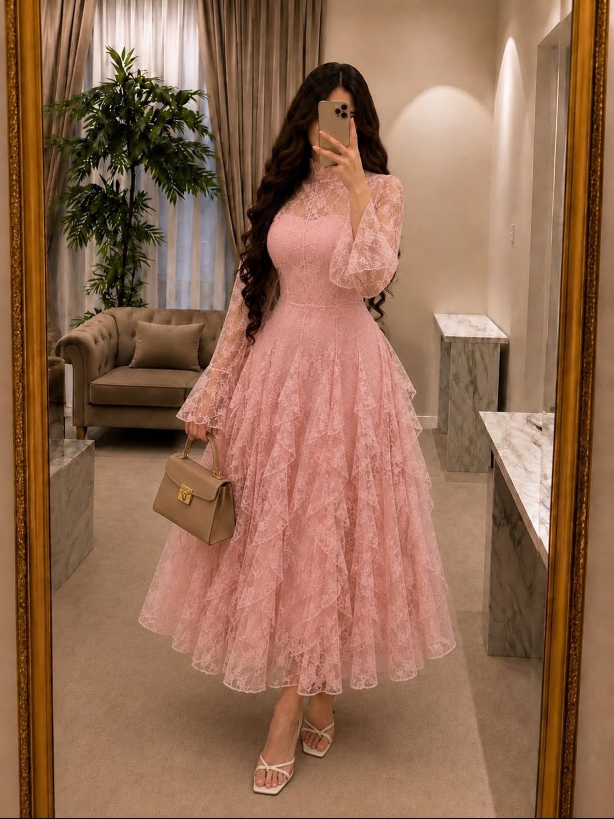 Tea Party Dresses: 6 Outfit Ideas for Brunches and Garden Events 5 A woman posing in a mirror wearing a long pink lace dress with a ruffled skirt and white sandals.