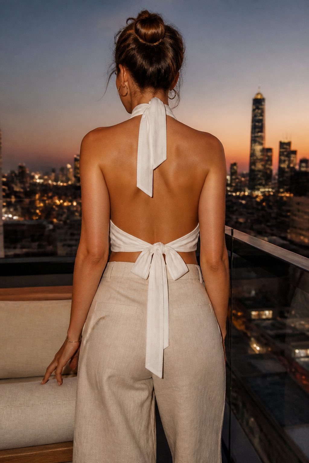 White Crop Top Styles for a Complete Wardrobe 4 White halter neck open back crop top displayed against a soft background.