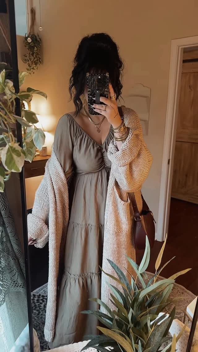 Women Travel Outfit: 8 Looks for Airport to City 3 Woman in a long olive green maxi dress and beige knit cardigan taking a mirror selfie.