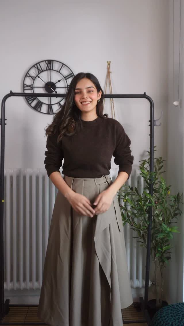 Women's Business Casual: 10 Outfit Ideas for the Office 10 A smiling woman posing in a brown sweater and long beige skirt.