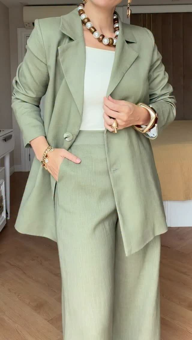 Work Outfits for Women: 7 Smart Office Looks for 2026 1 Woman wearing a sage green blazer and matching wide-leg trousers with gold accessories.