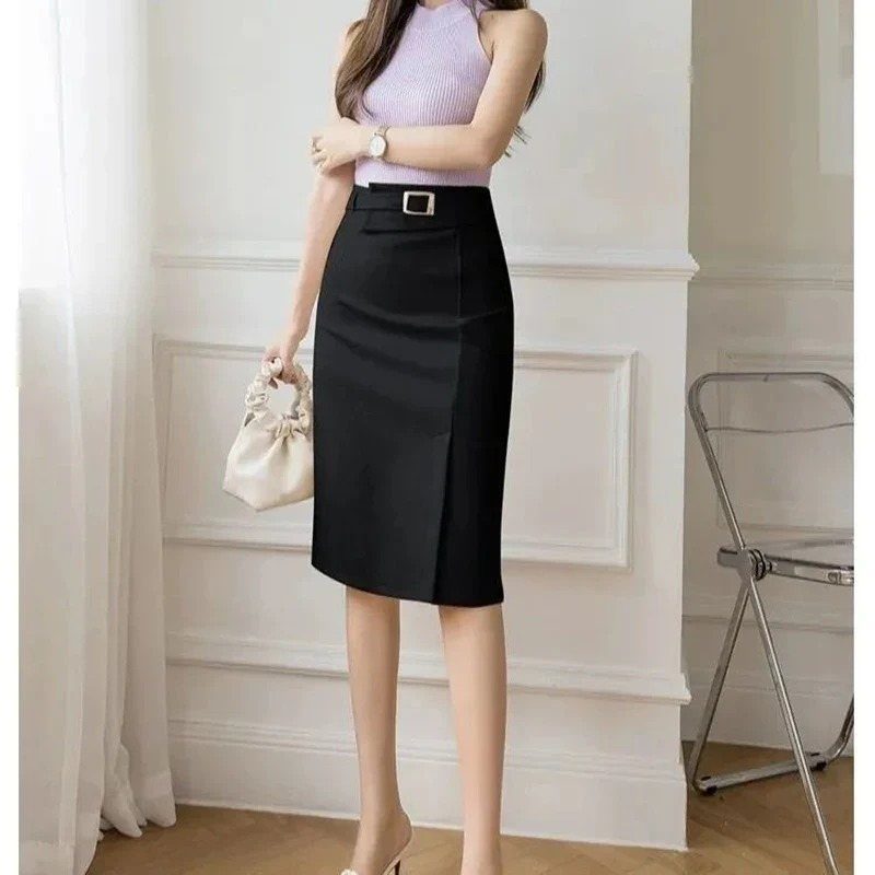 Work Outfits for Women: 7 Smart Office Looks for 2026 5 Woman wearing a purple knit top and a black high-waisted pencil skirt.