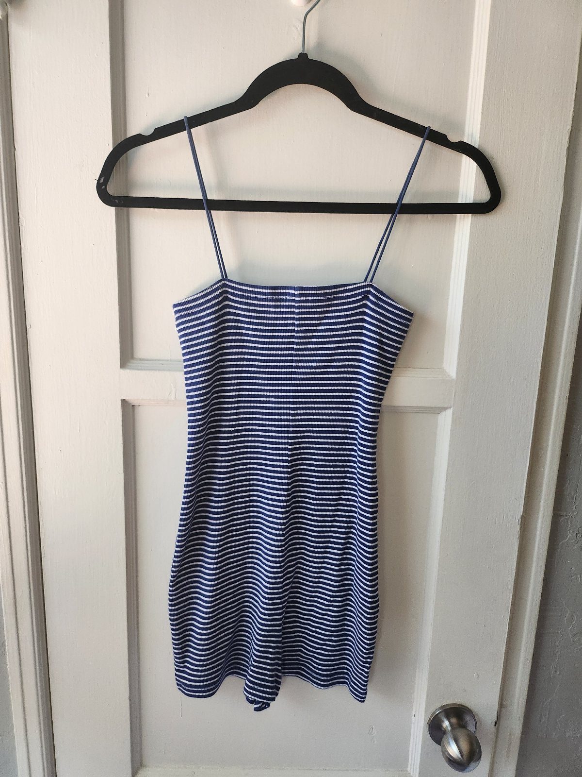 Zara Summer Dresses From Mini to Maxi (21 Characters) 10 Blue and white striped mini dress with spaghetti straps hanging on a white door.